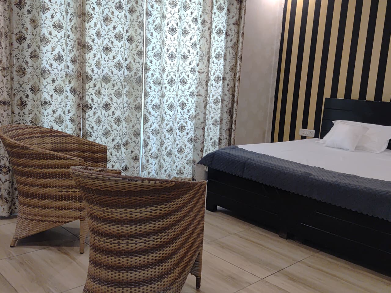 Stylish bedroom with wicker seating