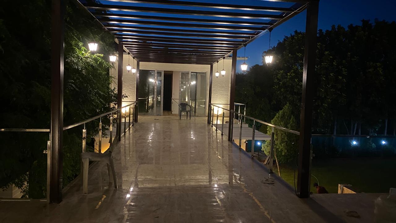 Pergola walkway with hanging lanterns at night