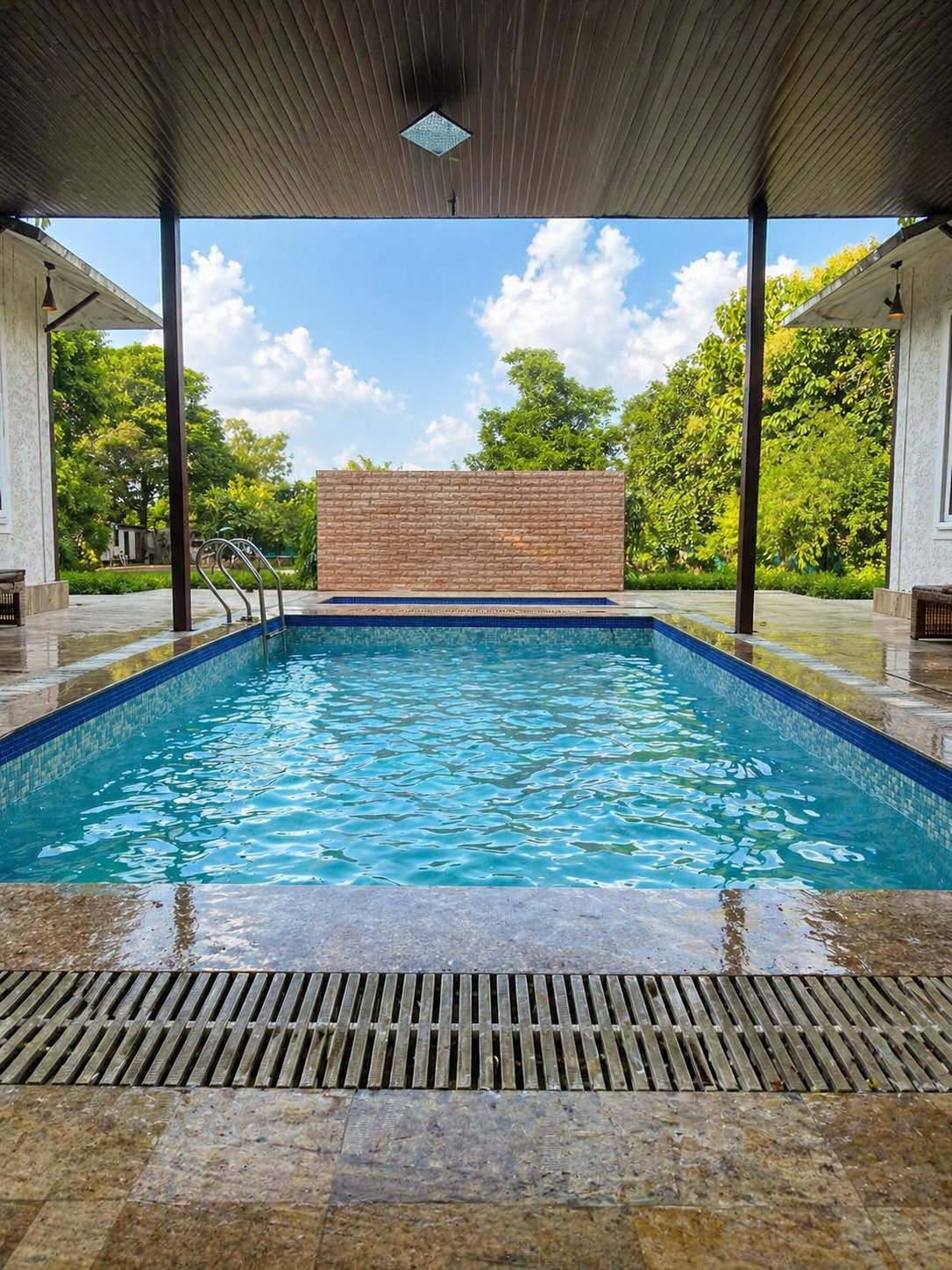 Luxury swimming pool at Angel Garden Farmhouse with covered shelter and brick fountain