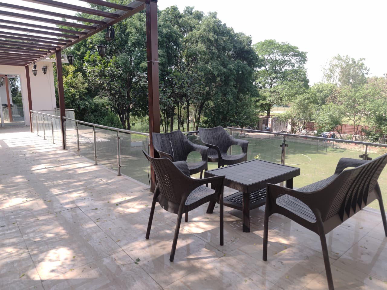 Upper balcony with seating overlooking lawn